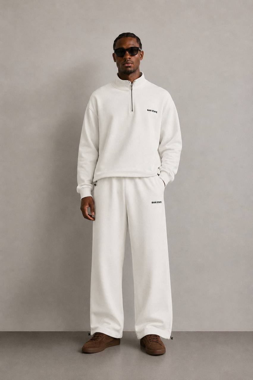 Model in the off-white half-zip set